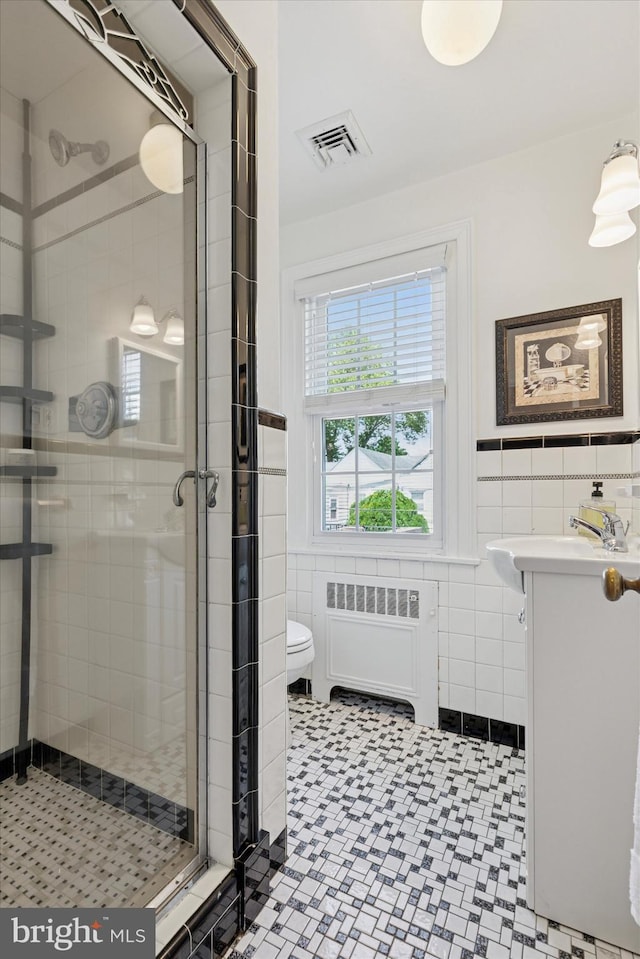 1417 Dorset Ln, Wynnewood, PA 19096 - bathroom with radiator, tile walls, vanity, a shower stall, and wainscoting