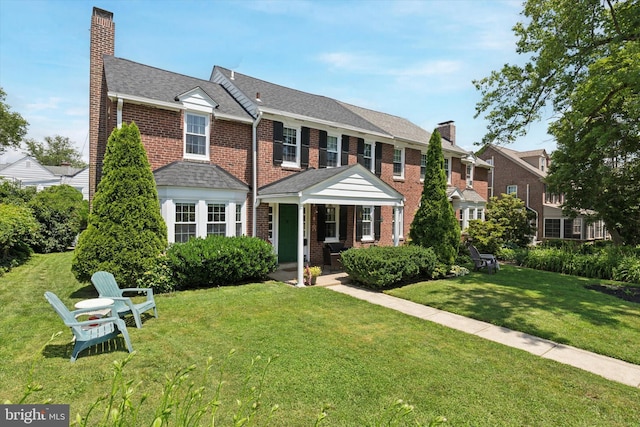 1417 Dorset Ln, Wynnewood, PA 19096 - view of front of home with a chimney, a front yard, and brick siding