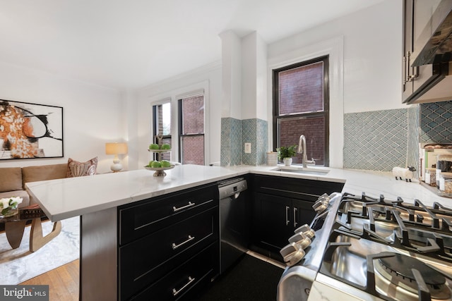 1915 16th St NW Unit 203, Washington, DC 20009 - kitchen featuring stainless steel dishwasher, dark cabinetry, under cabinet range hood, a peninsula, and ornamental molding
