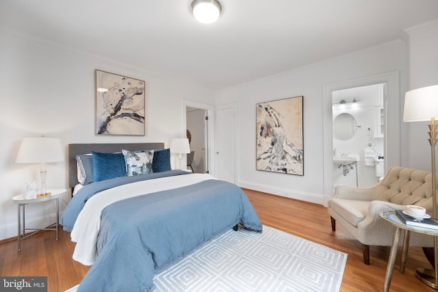 1915 16th St NW Unit 203, Washington, DC 20009 - bedroom featuring wood finished floors, crown molding, and ensuite bathroom