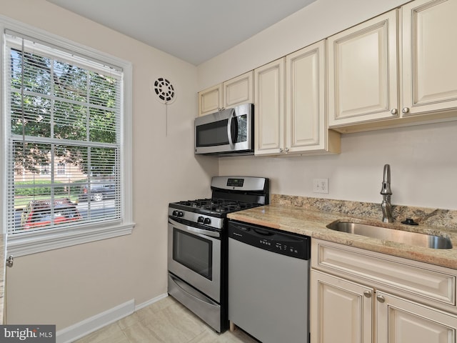 1515 Belle View Blvd Unit A1, Alexandria, VA 22307 - kitchen featuring appliances with stainless steel finishes, cream cabinets, light stone counters, and light tile patterned flooring