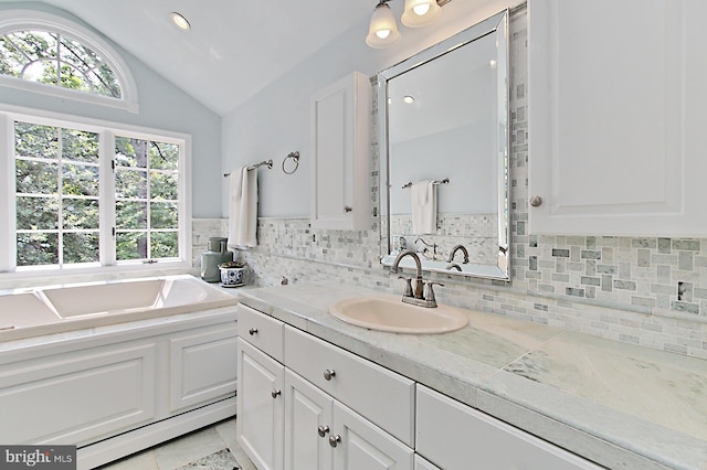3132 Holmes Run Rd, Falls Church, VA 22042 - bathroom with vaulted ceiling, a garden tub, tasteful backsplash, plenty of natural light, and recessed lighting
