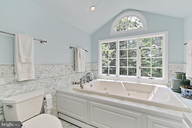 3132 Holmes Run Rd, Falls Church, VA 22042 - full bathroom with tile walls, a whirlpool tub, a wainscoted wall, and lofted ceiling