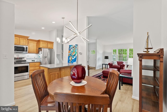 3472 Lyon Park Ct, Woodbridge, VA 22192 - dining area featuring light wood-style floors, a chandelier, vaulted ceiling, and recessed lighting