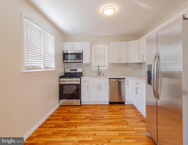 7 Flag St, Pemberton, NJ 08068 - kitchen featuring appliances with stainless steel finishes, backsplash, white cabinetry, and light countertops