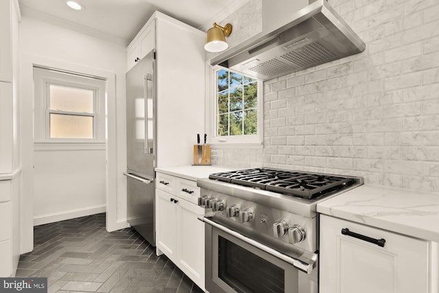 110 E Nelson Ave, Alexandria, VA 22301 - kitchen featuring high quality appliances, wall chimney range hood, decorative backsplash, plenty of natural light, and recessed lighting