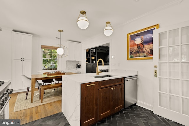 110 E Nelson Ave, Alexandria, VA 22301 - kitchen with stainless steel appliances, a peninsula, white cabinetry, light stone counters, and dark brown cabinets