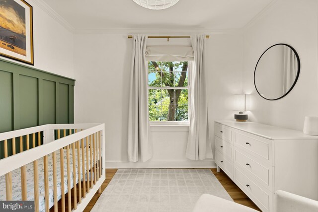110 E Nelson Ave, Alexandria, VA 22301 - bedroom featuring dark wood-type flooring, crown molding, and a crib