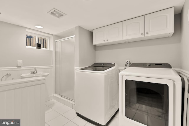 110 E Nelson Ave, Alexandria, VA 22301 - washroom with washing machine and clothes dryer, cabinet space, and light tile patterned floors