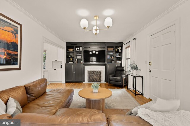 110 E Nelson Ave, Alexandria, VA 22301 - living room with light wood-style floors, a chandelier, crown molding, and a fireplace