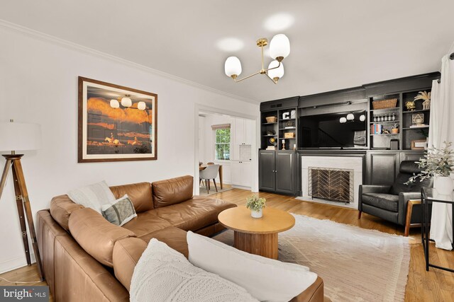 110 E Nelson Ave, Alexandria, VA 22301 - living room with crown molding, light wood-type flooring, a fireplace with flush hearth, and a chandelier