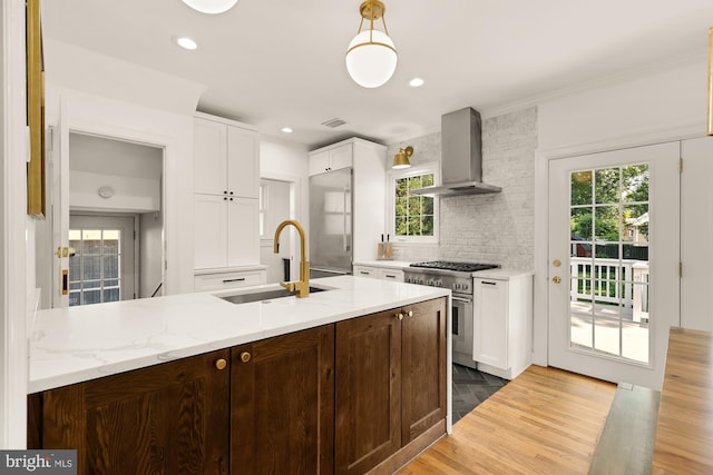 110 E Nelson Ave, Alexandria, VA 22301 - kitchen featuring ventilation hood, stainless steel stove, white cabinets, plenty of natural light, and recessed lighting