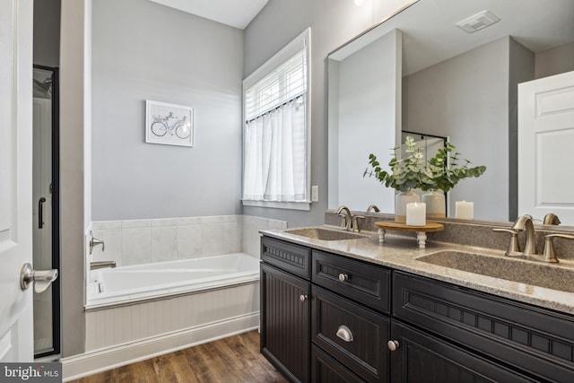 211 Hauer Ter, Spring Grove, PA 17362 - bathroom featuring double vanity, wood finished floors, and a garden tub