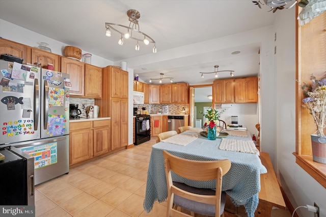 325 Beecher Ave, Cheltenham, PA 19012 - kitchen featuring stainless steel appliances, decorative backsplash, light countertops, and light tile patterned floors