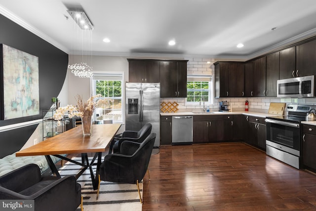 1778 W St SE, Washington, DC 20020 - kitchen featuring appliances with stainless steel finishes, crown molding, plenty of natural light, light countertops, and dark wood finished floors