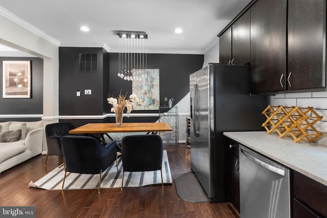 1778 W St SE, Washington, DC 20020 - kitchen featuring stainless steel dishwasher, ornamental molding, light countertops, dark wood-style flooring, and hanging light fixtures
