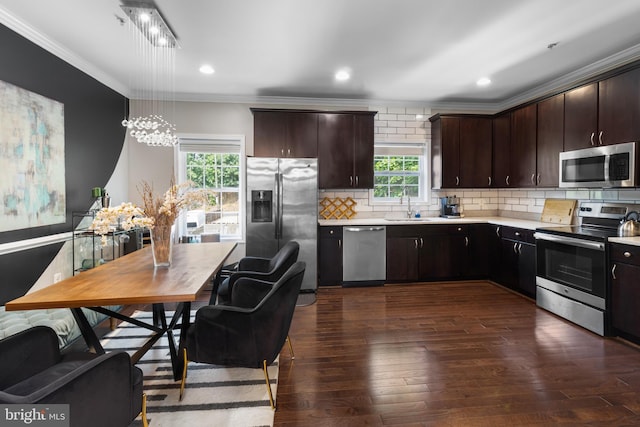 1778 W St SE, Washington, DC 20020 - kitchen with stainless steel appliances, ornamental molding, light countertops, healthy amount of natural light, and dark wood-type flooring