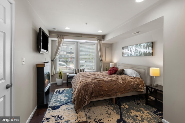 1778 W St SE, Washington, DC 20020 - bedroom featuring recessed lighting, wood finished floors, and a glass covered fireplace