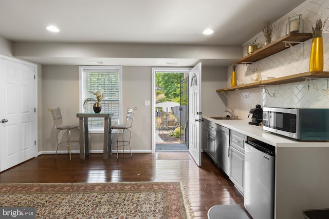 1778 W St SE, Washington, DC 20020 - kitchen with stainless steel appliances, dark wood-style flooring, open shelves, light countertops, and recessed lighting