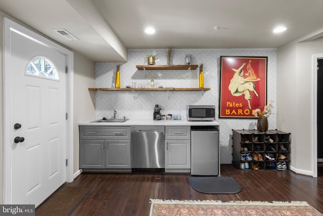 1778 W St SE, Washington, DC 20020 - indoor wet bar with stainless steel appliances, dark wood-style flooring, decorative backsplash, and recessed lighting