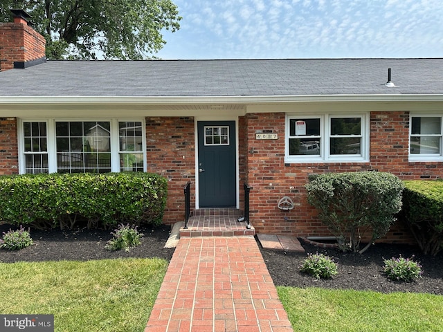 6087 8th Pl N, Arlington, VA 22205 - entrance to property featuring brick siding, a chimney, and roof with shingles