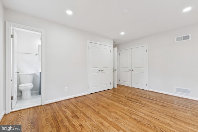 6087 8th Pl N, Arlington, VA 22205 - unfurnished bedroom featuring light wood-type flooring, recessed lighting, and ensuite bath