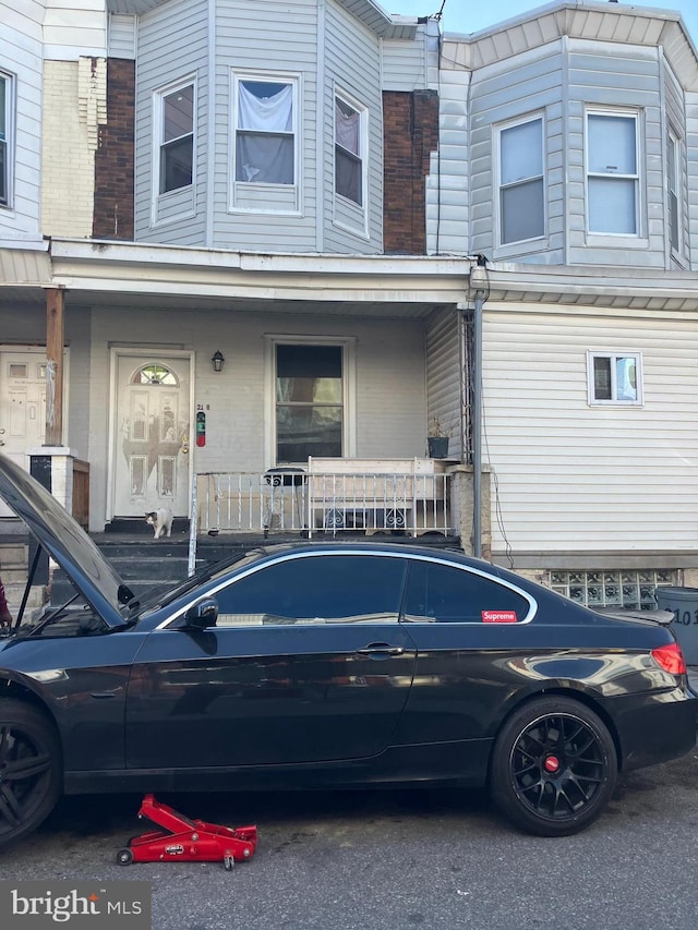 2118 S Shields St, Philadelphia, PA 19142 - townhome / multi-family property with a porch and brick siding