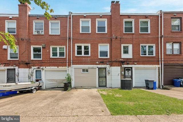 1319 E Vernon Rd, Philadelphia, PA 19150 - back of property featuring a garage, driveway, a chimney, and brick siding