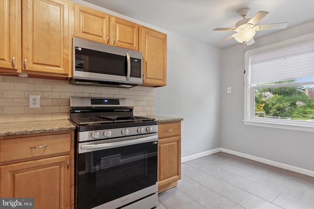 1319 E Vernon Rd, Philadelphia, PA 19150 - kitchen featuring appliances with stainless steel finishes, decorative backsplash, light stone countertops, light tile patterned floors, and a ceiling fan