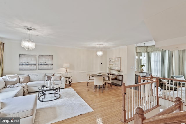 440 Clayton Ln, Alexandria, VA 22304 - living room with a chandelier, light wood-type flooring, and ornamental molding