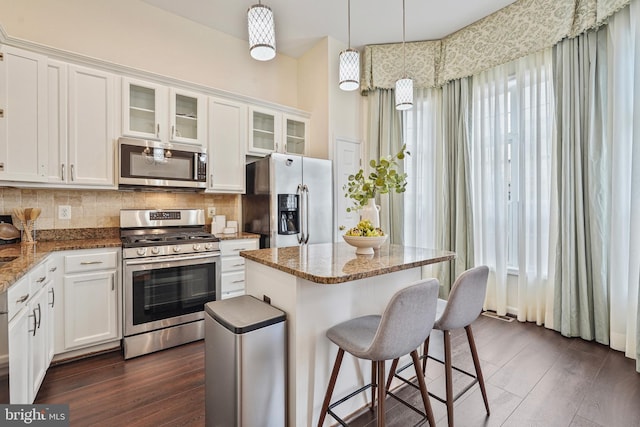 440 Clayton Ln, Alexandria, VA 22304 - kitchen featuring stainless steel appliances, dark wood-type flooring, tasteful backsplash, and white cabinetry
