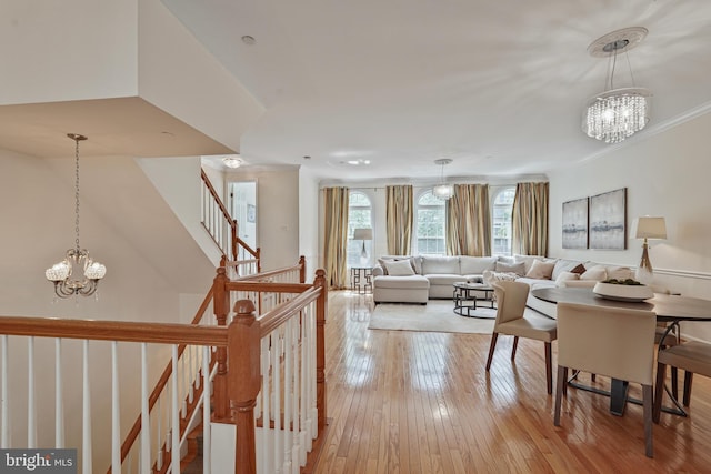 440 Clayton Ln, Alexandria, VA 22304 - living room with a chandelier, light wood-style floors, stairs, and crown molding