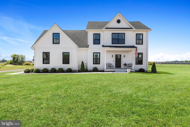 24766 Tribbett Cir, Ridgely, MD 21660 - modern farmhouse style home with a front yard, a shingled roof, and covered porch