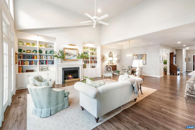 312 Avondale Ln, Crozet, VA 22932 - living room with high vaulted ceiling, wood finished floors, a ceiling fan, a glass covered fireplace, and recessed lighting