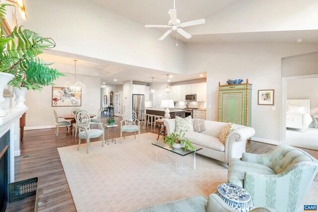 312 Avondale Ln, Crozet, VA 22932 - living area with wood finished floors, a fireplace, ceiling fan, a chandelier, and high vaulted ceiling