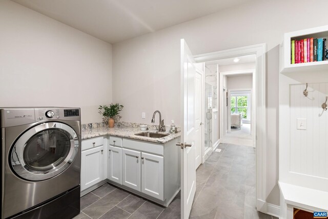 312 Avondale Ln, Crozet, VA 22932 - laundry area with washer / dryer, cabinet space, and dark tile patterned flooring