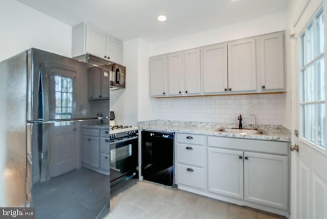 421 Jefferson St NE, Washington, DC 20011 - kitchen featuring black dishwasher, range with gas cooktop, healthy amount of natural light, decorative backsplash, and recessed lighting