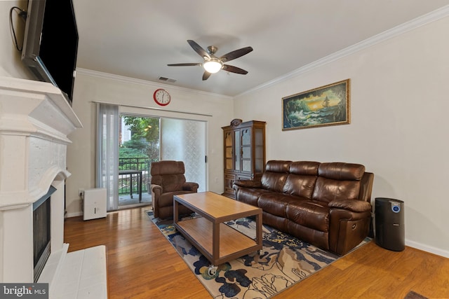 12921 Centre Park Cir Unit 102, Herndon, VA 20171 - living area with ceiling fan, wood finished floors, ornamental molding, and a fireplace with flush hearth