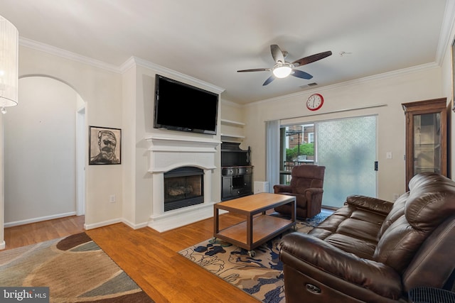 12921 Centre Park Cir Unit 102, Herndon, VA 20171 - living area with a ceiling fan, a fireplace with raised hearth, wood finished floors, arched walkways, and ornamental molding