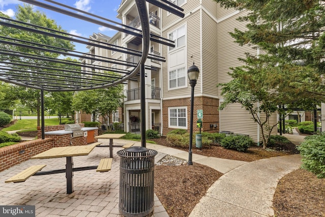 12921 Centre Park Cir Unit 102, Herndon, VA 20171 - surrounding community with an outdoor kitchen and a pergola