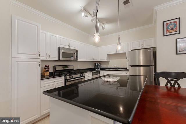 12921 Centre Park Cir Unit 102, Herndon, VA 20171 - kitchen with stainless steel appliances, dark countertops, white cabinetry, crown molding, and hanging light fixtures