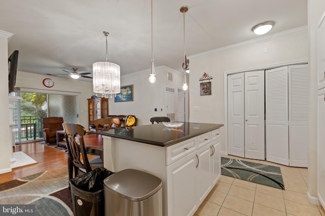 12921 Centre Park Cir Unit 102, Herndon, VA 20171 - kitchen with dark countertops, ceiling fan, open floor plan, ornamental molding, and a chandelier