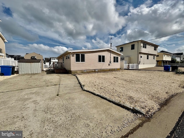 51 Ralph Ln, Manahawkin, NJ 08050 - rear view of property with a storage unit, a residential view, and a deck