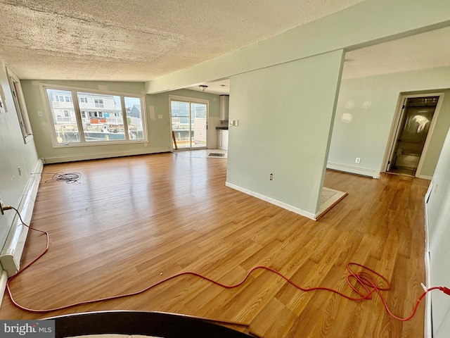 51 Ralph Ln, Manahawkin, NJ 08050 - spare room featuring baseboard heating, a textured ceiling, and wood finished floors