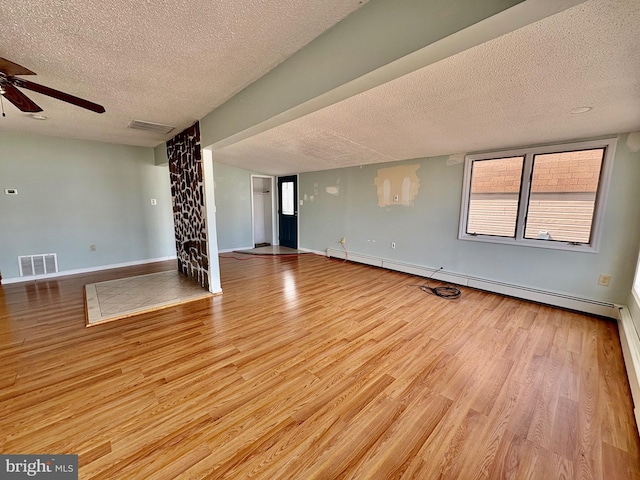 51 Ralph Ln, Manahawkin, NJ 08050 - unfurnished room with a textured ceiling, wood finished floors, a ceiling fan, and a baseboard heating unit