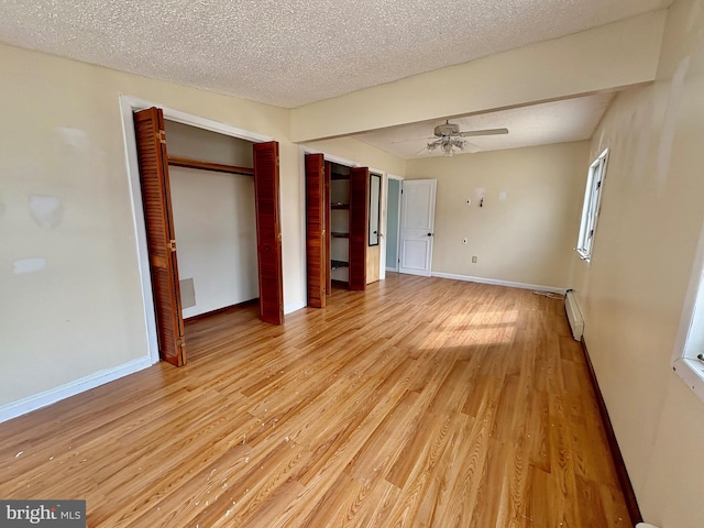 51 Ralph Ln, Manahawkin, NJ 08050 - unfurnished bedroom featuring light wood-style flooring, a textured ceiling, and a ceiling fan