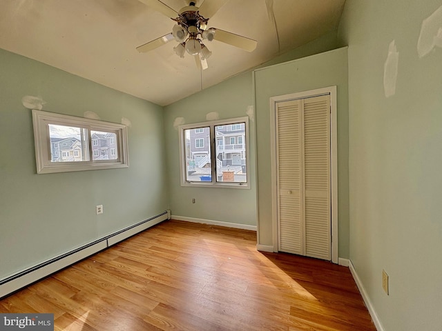 51 Ralph Ln, Manahawkin, NJ 08050 - unfurnished bedroom featuring lofted ceiling, baseboard heating, multiple windows, and light wood-type flooring
