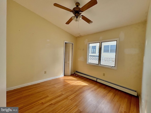 51 Ralph Ln, Manahawkin, NJ 08050 - empty room with a baseboard radiator, light wood-type flooring, vaulted ceiling, and a ceiling fan