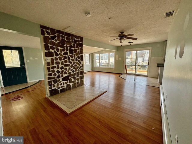 51 Ralph Ln, Manahawkin, NJ 08050 - unfurnished living room with a textured ceiling, wood finished floors, ceiling fan, and plenty of natural light