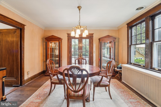 4009 Oglethorpe St, Hyattsville, MD 20782 - dining area with radiator, a chandelier, wood finished floors, and crown molding